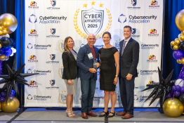Dave Tohn of BTS Software Solutions receiving the Cybersecurity Award from Senator Katie Hester at the 2025 Cybersecurity Awards.